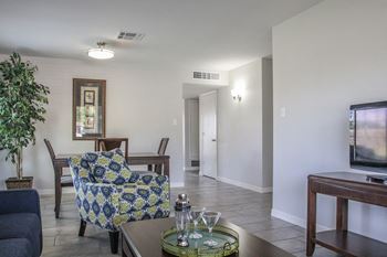 A living room and dining room with a tv and a table